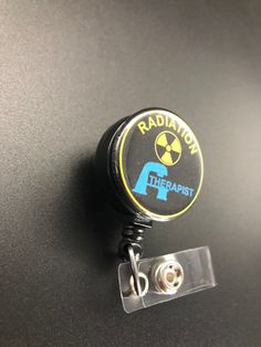 This unique retractable badge holder is adorable and useful. A great gift for any Radiation Therapist! These will be made with a belt clip back. If you prefer a swivel clip, let me know in the notes to seller section when checking out. Thank you!! :) Black Retractable Badge Holders As Gift, Black Retractable Badge Reel For Gift, Adjustable Black Retractable Badge Holder, Black Adjustable Retractable Badge Holders, Black Badge Reel With Swivel Clip As A Gift, Radiation Therapist Gifts, Radiation Therapist, Xray Tech, Retractable Badge Holder