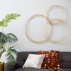 a living room filled with furniture and a large metal circle wall decoration above the couch