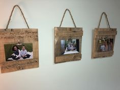 three wooden frames hanging on the wall with photos attached to them and twine rope