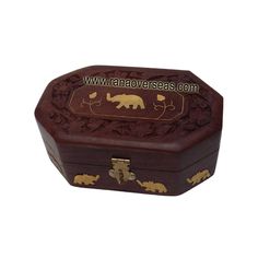 an ornate wooden box with elephants and flowers on the lid is shown in this image