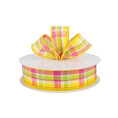 a yellow and pink plaid ribbon on top of a white box with an orange bow