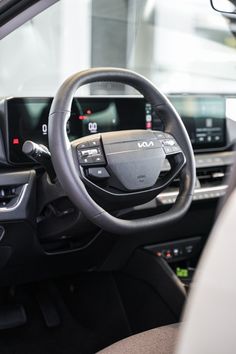 the interior of a car with dashboard controls and steering wheel, including an electronic display