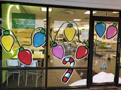 a store front window decorated with fruit and vegetables