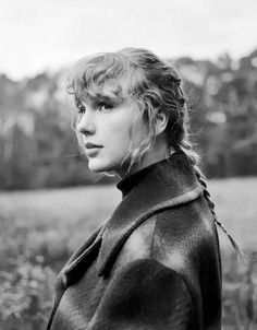 a black and white photo of a woman in a leather jacket looking off into the distance