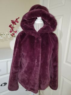 Simply Vera Vera Wang Ladies  Burgundy Ultra Soft Faux Fur Hooded Coat Jacket  Sz. Small Brand: Simply Vera Vera Wang RN # 73277 Style # 75284  08/19 Women`s size: Small - Fits right size Material: Shell: Faux Fur 100% Polyester  Lining: 100% Polyester Color: Burgundy Dry Clean Only Made in China This faux fur hooded jacket feels luxuriously soft and light. Great burgundy color. Wide fully fur lined comfort hood. 4 snap buttons closure. Long sleeves. Fully lined.  It is very warm and cozy for the colder months. So stylish and worm! Approximate Measurements (lying flat): Chest, across under the arms (pit to pit): 20" Shoulders: 17" Waist across: 21" Hips across: 23" Length from shoulder seam to the bottom: 25" Length of the sleeve: 24" Brand New without tag. No Defects. If you have any ques Fur Hooded Coat, Fur Hooded Jacket, Faux Fur Hooded Jacket, Faux Fur Hooded Coat, Simply Vera Wang, Simply Vera, Hooded Coat, Burgundy Color, Vera Wang