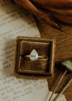 an engagement ring sitting in a box on top of a table