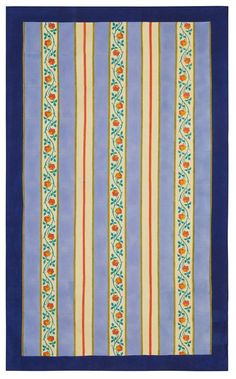 a blue and yellow striped rug with an orange flower design on the bottom half of it