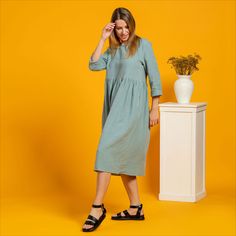 Woman wearing maternity dress from linen in mint green color Spring Smock Midi Dress With Relaxed Fit, Relaxed Fit Smock Dress For Daywear, Spring Midi Dress With Smock And Relaxed Fit, Smocked Relaxed Fit Midi Dress, Relaxed Fit Midi Smock Dress, Casual Smock Dress With Relaxed Fit, Green Relaxed Fit Midi Dress For Daywear, Casual Green Smock Midi Dress, Casual Smock Dresses For Daywear