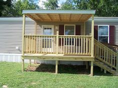 a small house with a deck in front of it