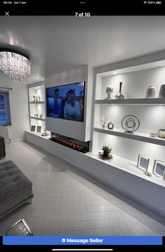 a living room filled with furniture and a flat screen tv mounted to the wall above it