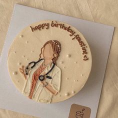 a birthday cake with a woman doctor on it