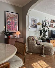 a living room filled with furniture and a flat screen tv sitting on top of a wooden floor