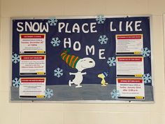 a bulletin board with snow place like home written on it and a cartoon dog wearing a hat