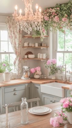 a kitchen filled with lots of pink flowers and greenery hanging from the ceiling next to a sink