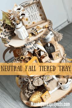 a wooden stand with various items on it and the words neutral fall - tiered tray