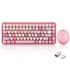 a pink computer keyboard and mouse on a white surface