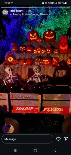 a halloween display with pumpkins and jack - o'- lanterns in the background