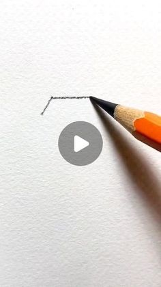 an orange pencil drawing a line on white paper