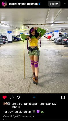 a woman is standing in a parking garage holding onto a pole with her arms and legs