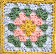 a crocheted square is shown with different colored yarns in the shape of flowers