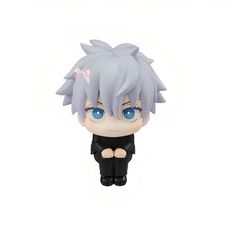 an anime figurine with blue eyes is sitting on the white surface and looks like he