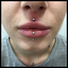 a woman with piercings on her nose