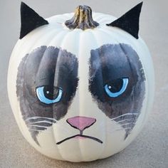 a painted pumpkin with a cat's face on it