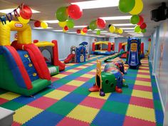 an inflatable bounce house is decorated with balloons