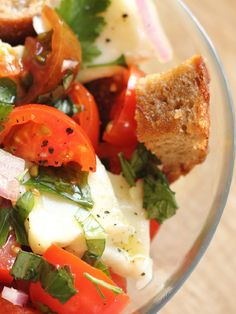 a glass bowl filled with lots of different types of food