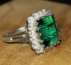 GORGEOUS vintage 14K white gold ring natural green tourmaline in emerald shape center natural tourmaline weight 4.35ct. size 12x9.1mm very nice rich green color nice luster, very lively ,nice cut.clean brilliant  stone. side set natural diamonds total weight 1.37ct. G-SI1 Beautiful settings ring .ring size 7.5Resizable Appraisal available Retail value $8,500 net. Collectible Emerald Cut Green Emerald Ring, Beautiful Settings, Champagne Diamonds Engagement, Platinum Engagement Rings Vintage, Filigree Engagement Ring, Sparkling Rings, Platinum Engagement Rings, Rich Green, Champagne Diamond