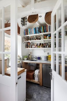 an open kitchen with lots of books on the shelves