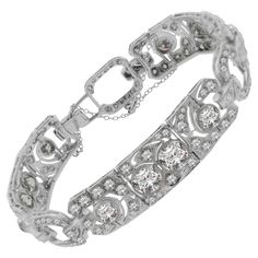 A true treasure from the Art Deco era, circa 1930, this bracelet features approximately 16 carats of diamonds set in lovely patterns around open platinum work. Five of the largest diamonds on the bracelet weigh over 1 carat each! The diamond settings are finished with hand applied millgrain in traditional deco fashion. Hand-fabricated in platinum, a fine Art Deco diamond bracelet worth of any collection. Length: 7 inches Vintage Diamond Bracelet, Bracelet Art, Platinum Bracelet, Retro Bracelet, Deco Fashion, Art Deco Bracelet, Rene Lalique, Diamond Settings, European Cut Diamonds