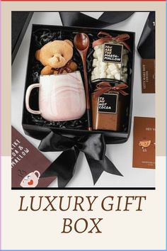 the luxury gift box is filled with chocolates, marshmallows and a teddy bear