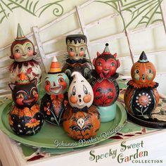 an assortment of painted pumpkins on a plate