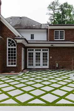 a large brick house with white doors and windows