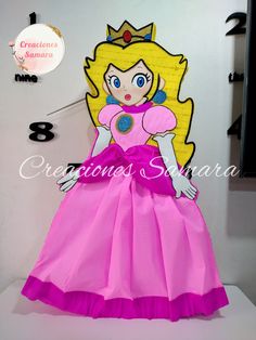 a pink princess dress on display in front of a clock