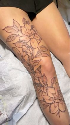 a woman's leg with flowers on it