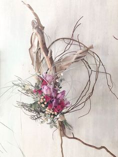 a bouquet of flowers and twigs on a white background with no leaves or branches in the foreground