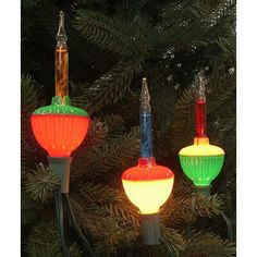 three colorful lights are hanging from a christmas tree