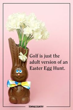 an easter bunny vase with white flowers in it on a pink background that says, golf is just the adult version of an easter egg hunt