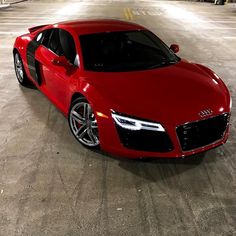 a red sports car parked in an empty parking lot