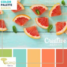 grapefruits and mint leaves are arranged on a blue wooden table with color swatches