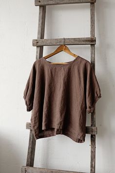 Tunic is made from 100% soft and washed linen. Match it with our skirts! Details: - Composition: 100% Oeko-Tex certified linen - Colour: cacao - Button in the back - Dropped shoulders - Size: One size/fits all - Medium weight linen - Linen care: machine wash gentle; tumble dry low, ironing optional - The price is for one tunic, other pictured items are not included Measurements: Length from neck down: 55 cm (21,66 in) Chest width: 140 cm (55,1 in) Sleeve length (from collar): 37 cm (14,6 in) Bot Bohemian Linen Tops With Relaxed Fit, Bohemian Linen Relaxed Fit Tops, Flax Cotton Relaxed Fit Blouse, Relaxed Fit Cotton Blouse In Beige, Flax Cotton Blouse With Relaxed Fit, Oversized Bohemian Linen Tops, Brown Linen Spring Tops, Brown Linen Tops For Spring, Brown Relaxed Fit Linen Blouse