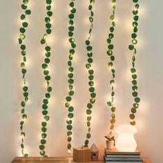 a string of lights hanging from the side of a wall next to a book on a table