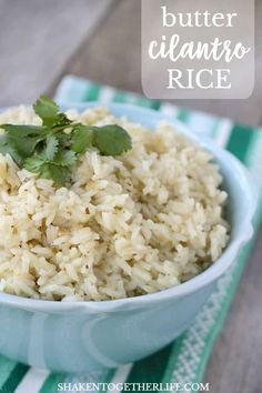 a blue bowl filled with rice and cilantro on top of a striped towel