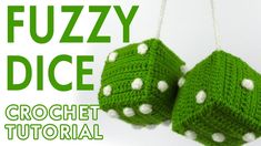 two green crocheted dices hanging from chains with the words fuzzy dice on them