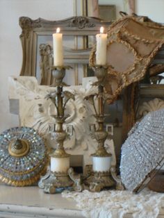 a mantle with candles and other items on it