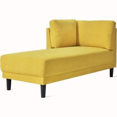 a yellow couch sitting on top of a white floor