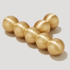 five golden balls are arranged in a row