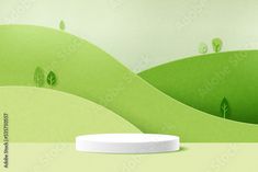 a white round object sitting on top of a green hill